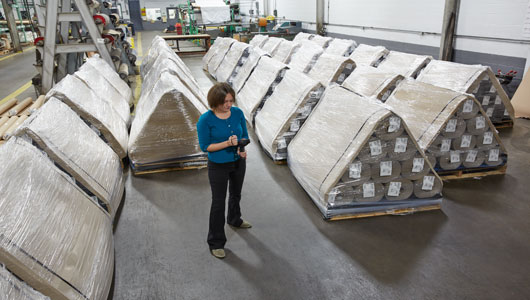 Woman overseeing on-time delivery schedule of custom roll bundles